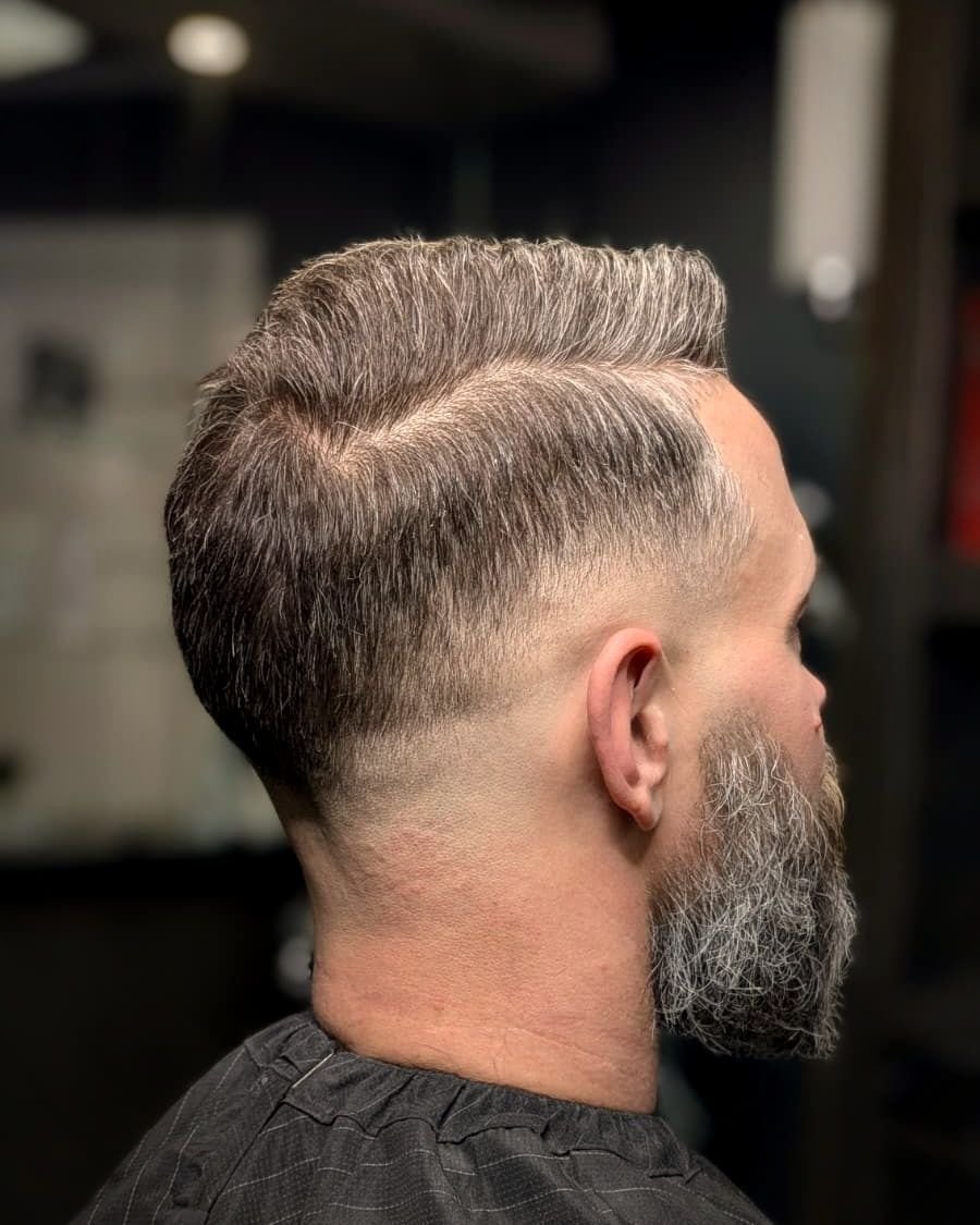 Side part with a skin fade and grey beard, BC Barber Shop