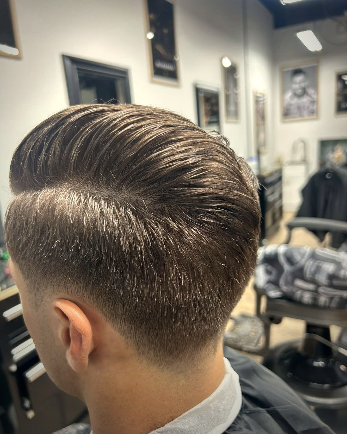 Slicked back hair with a clean taper, BC Barber Shop