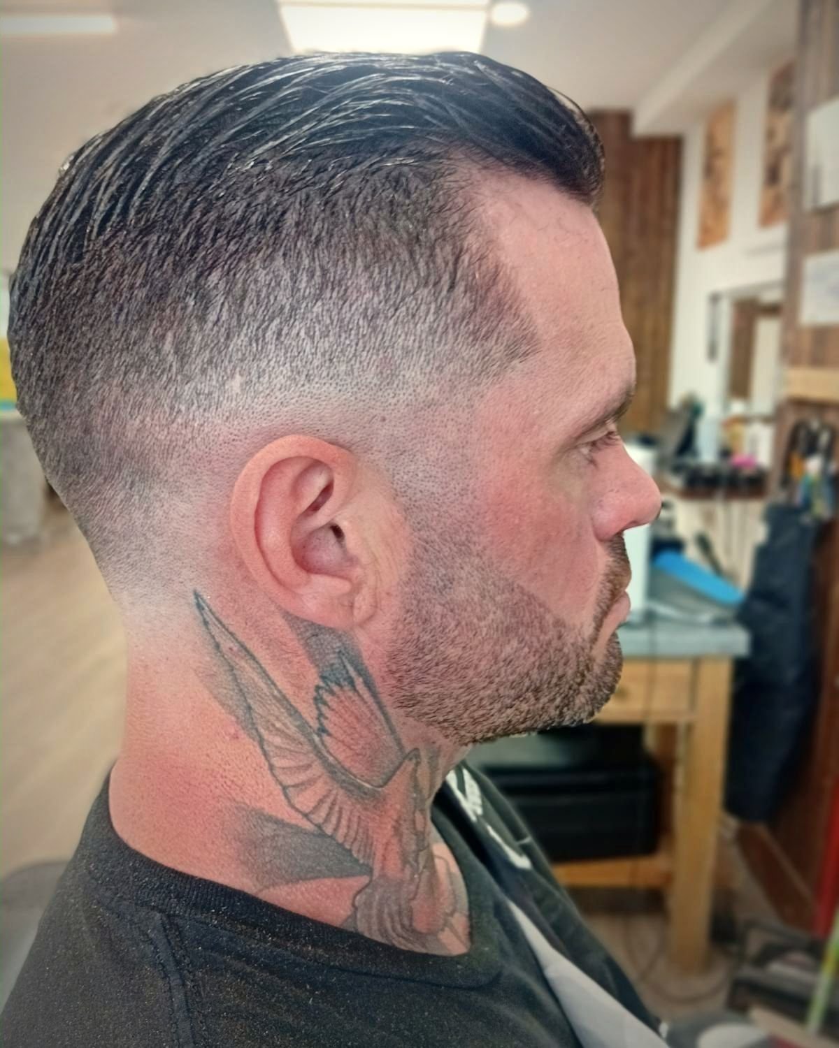 Slick comb over with a skin fade and trimmed beard, BC Barber Shop